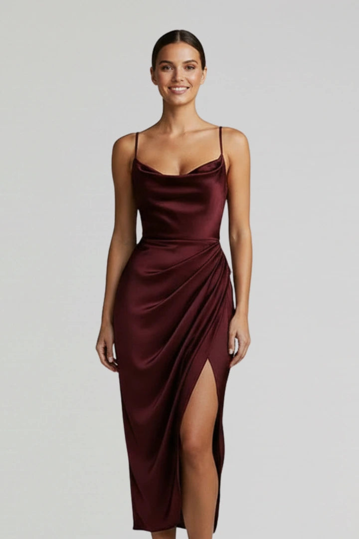 Woman wearing a burgundy slim strap draped dress - studio photo