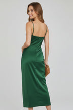 Woman wearing a green slim strap draped dress - studio photo