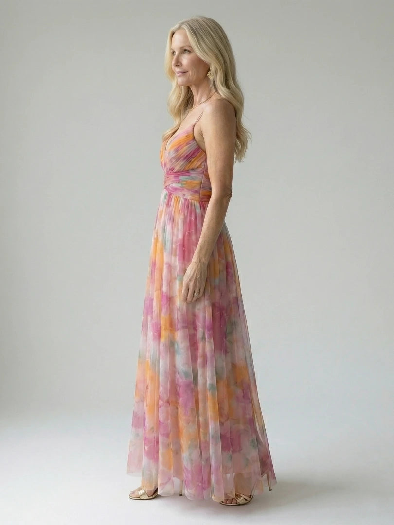 Woman wearing a multicolour soft wrap maxi dress - studio photo