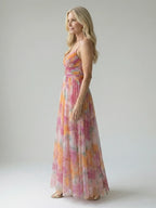 Woman wearing a multicolour soft wrap maxi dress - studio photo