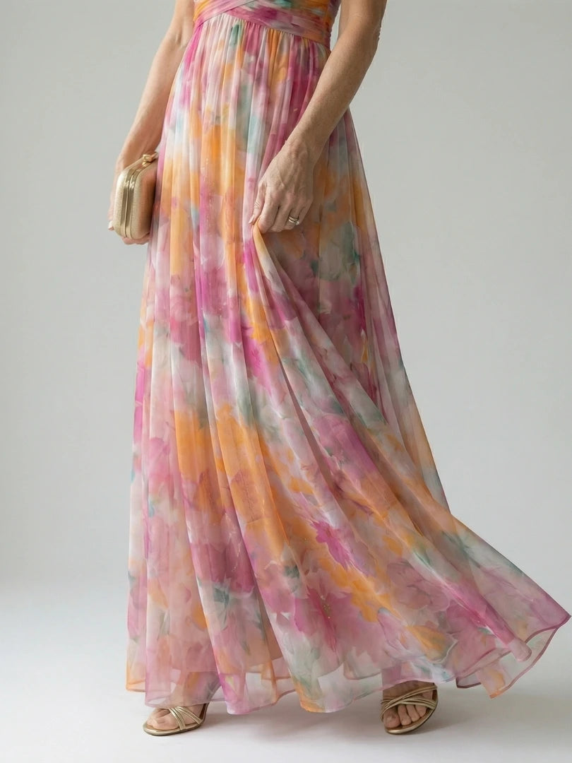 Woman wearing a multicolour soft wrap maxi dress - studio photo