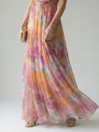 Woman wearing a multicolour soft wrap maxi dress - studio photo