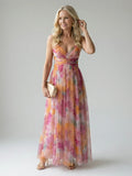 Woman wearing a multicolour soft wrap maxi dress - studio photo