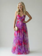 Woman wearing a pink soft wrap maxi dress - studio photo