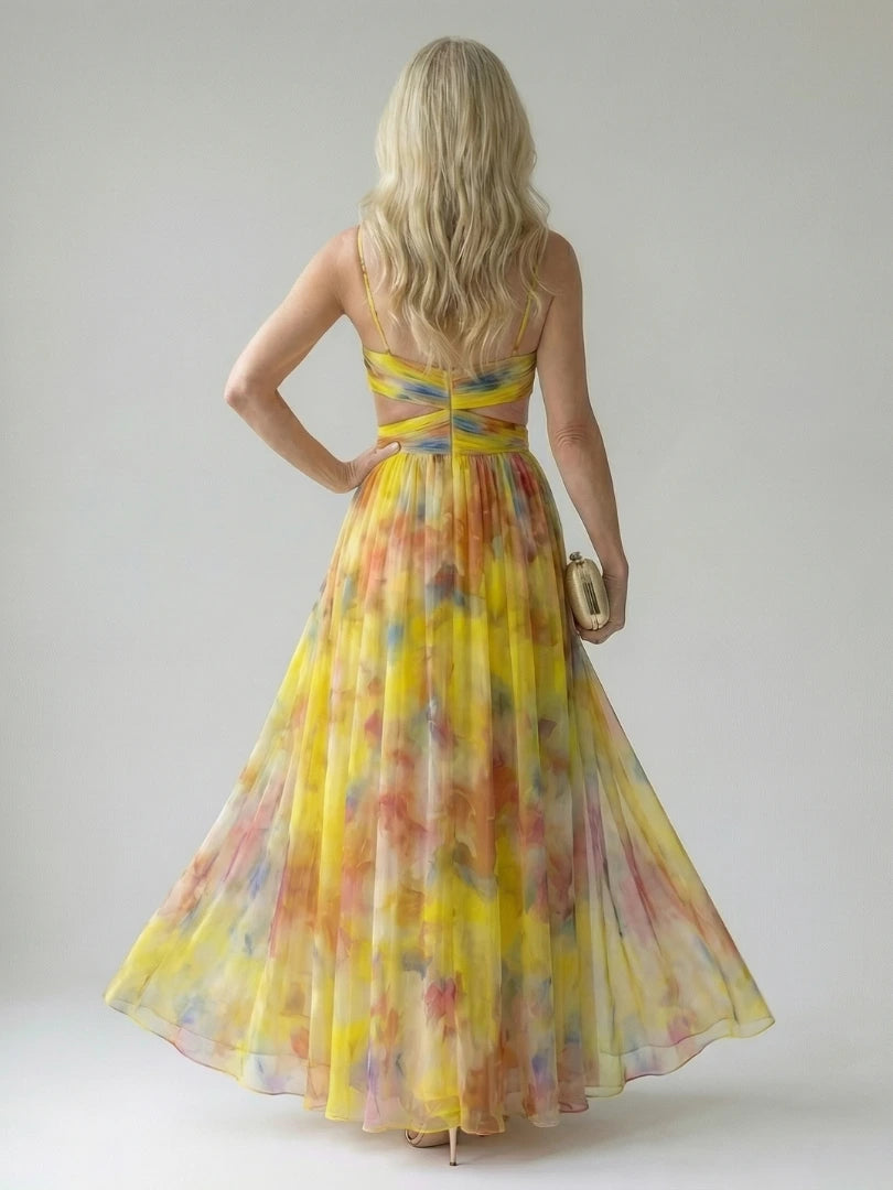 Woman wearing a yellow soft wrap maxi dress - studio photo
