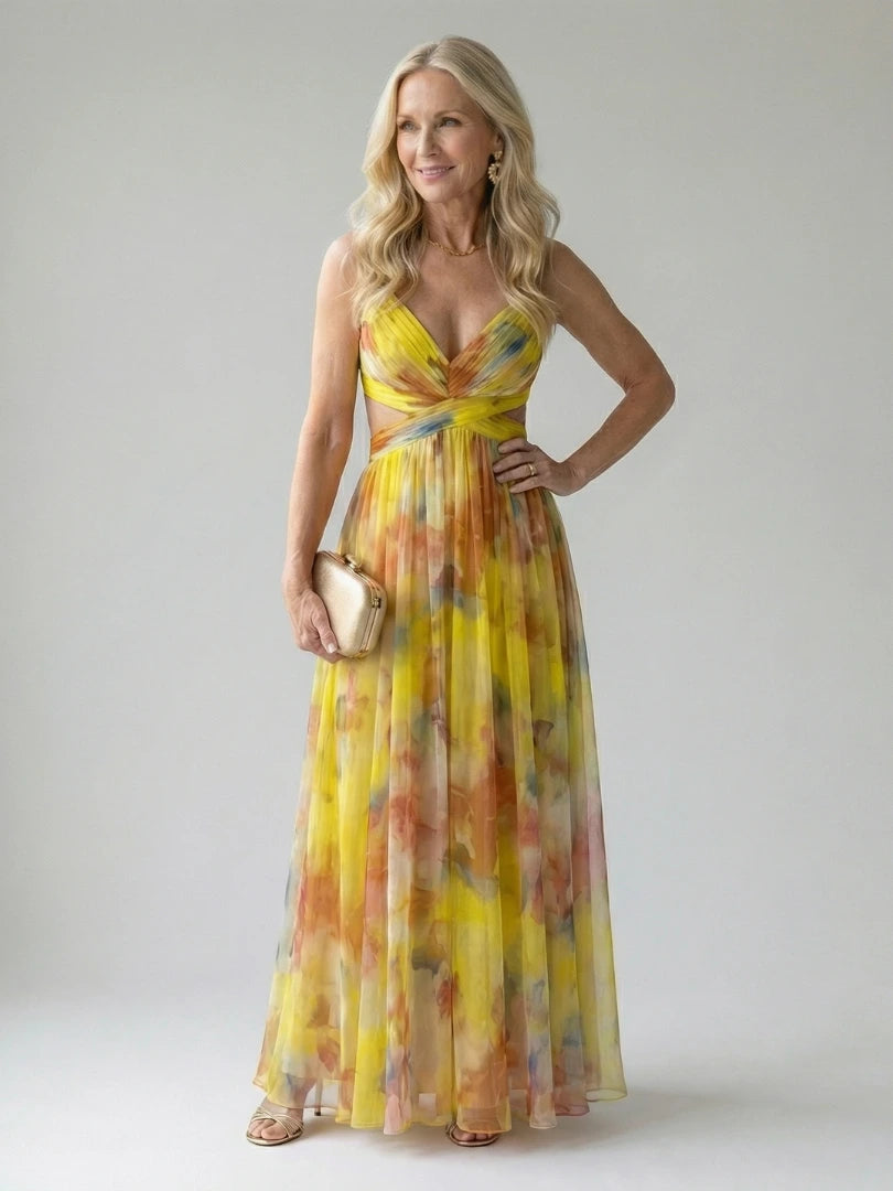 Woman wearing a yellow soft wrap maxi dress - studio photo