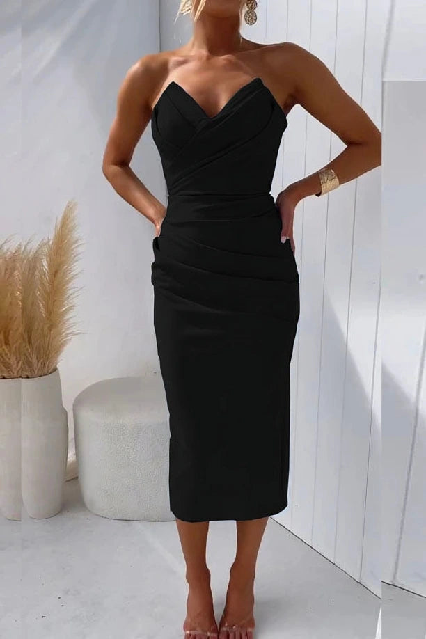 Woman wearing a black solid cocktail midi dress - studio photo