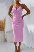 Woman wearing a pink solid cocktail midi dress - studio photo