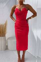 Woman wearing a red solid cocktail midi dress - studio photo