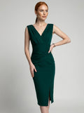 Woman wearing a green solid midi dress, studio photo, hand on hip pose
