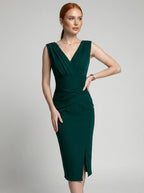 Woman wearing a green solid midi dress, studio photo, hand on hip pose