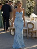 Woman wearing a sky blue spaghetti strap corset maxi dress - editorial style photo