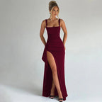 Woman wearing a burgundy square neck high slit maxi dress - studio photo