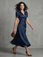 Woman wearing a blue stripe pleated midi dress - studio photo