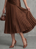 Woman wearing a brown stripe pleated midi dress - lifestyle photo
