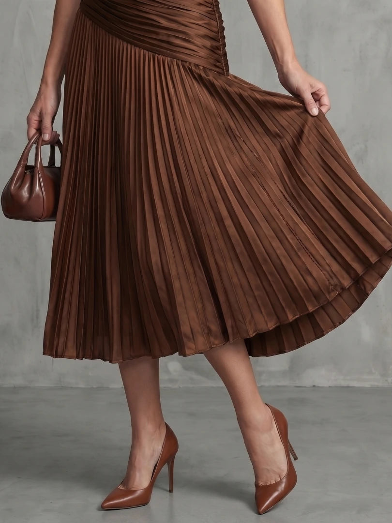 Woman wearing a brown stripe pleated midi dress - lifestyle photo