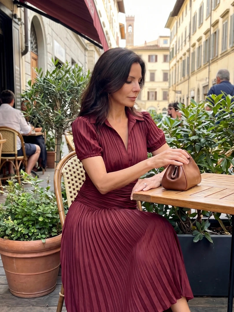 Woman wearing a brown stripe pleated midi dress - lifestyle photo