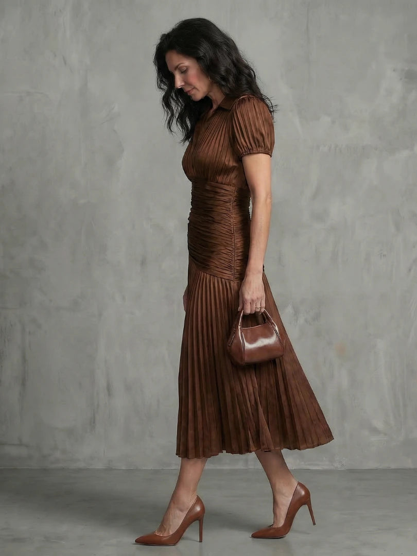 Woman wearing a brown stripe pleated midi dress - studio photo