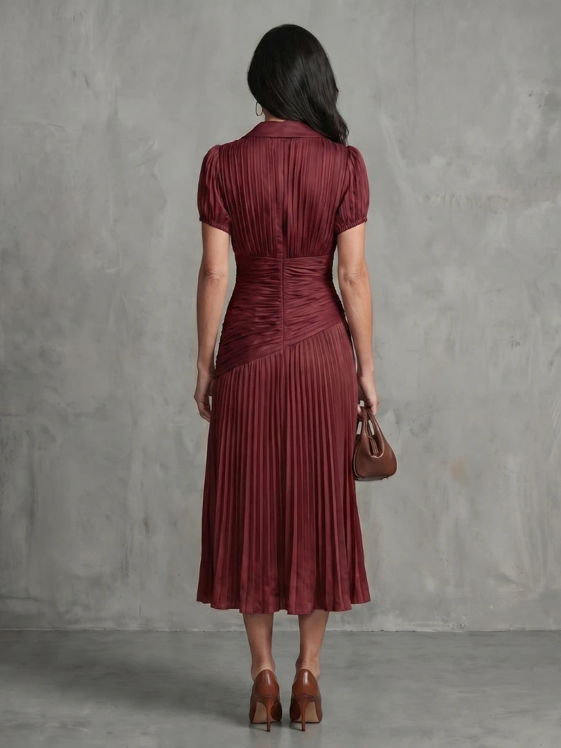 Woman wearing a brown stripe pleated midi dress - studio photo