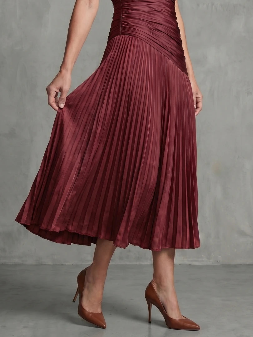 Woman wearing a red stripe pleated midi dress - studio photo