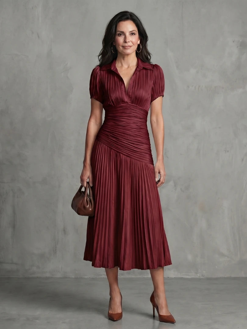 Woman wearing a red stripe pleated midi dress - studio photo