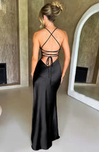 Woman wearing a black thin strap high slit maxi dress - studio photo