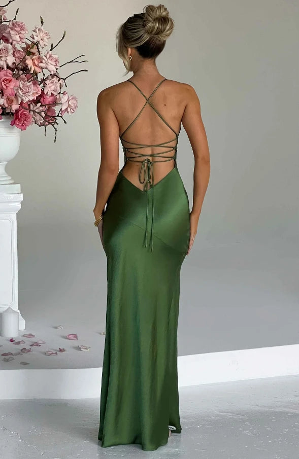Woman wearing a emerald thin strap high slit maxi dress - studio photo
