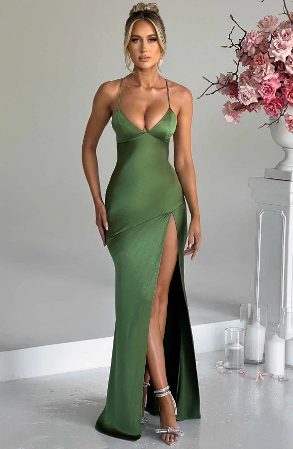 Woman wearing a emerald thin strap high slit maxi dress - studio photo