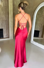 Woman wearing a red thin strap high slit maxi dress - studio photo