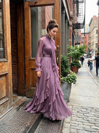 Woman wearing a purple tie neck ruffle tiered maxi dress - editorial style photo