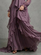 Woman wearing a purple tie neck ruffle tiered maxi dress - editorial style photo