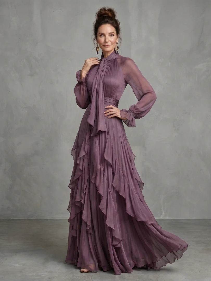 Woman wearing a purple tie neck ruffle tiered maxi dress - studio photo