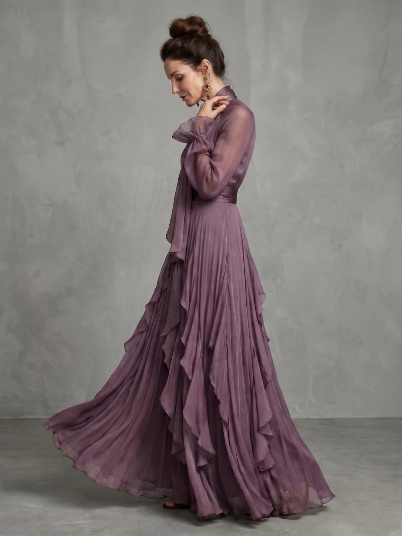Woman wearing a purple tie neck ruffle tiered maxi dress - studio photo