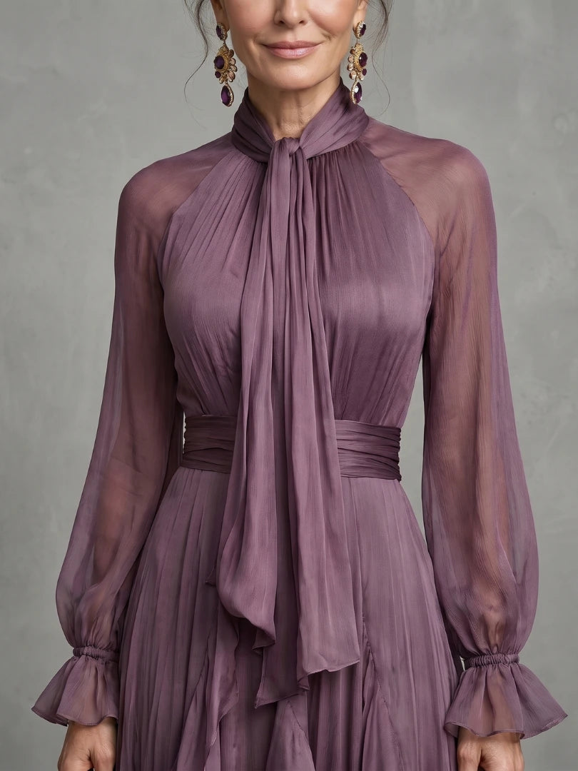 Woman wearing a purple tie neck ruffle tiered maxi dress - studio photo