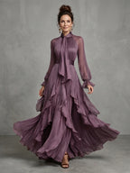 Woman wearing a purple tie neck ruffle tiered maxi dress - studio photo