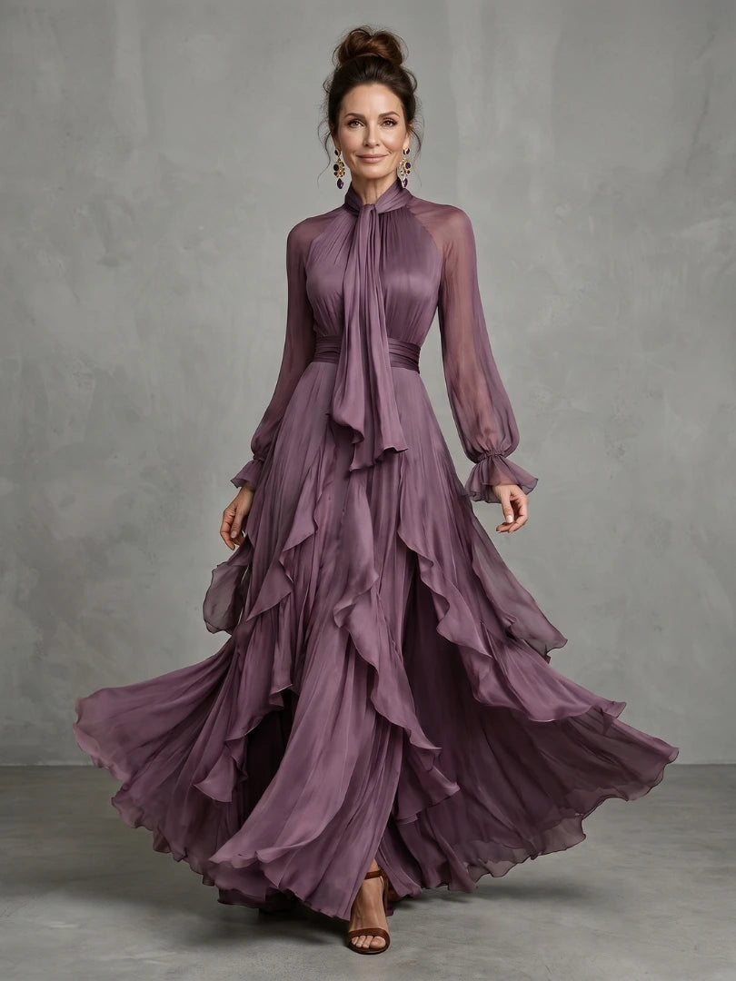 Woman wearing a purple tie neck ruffle tiered maxi dress - studio photo