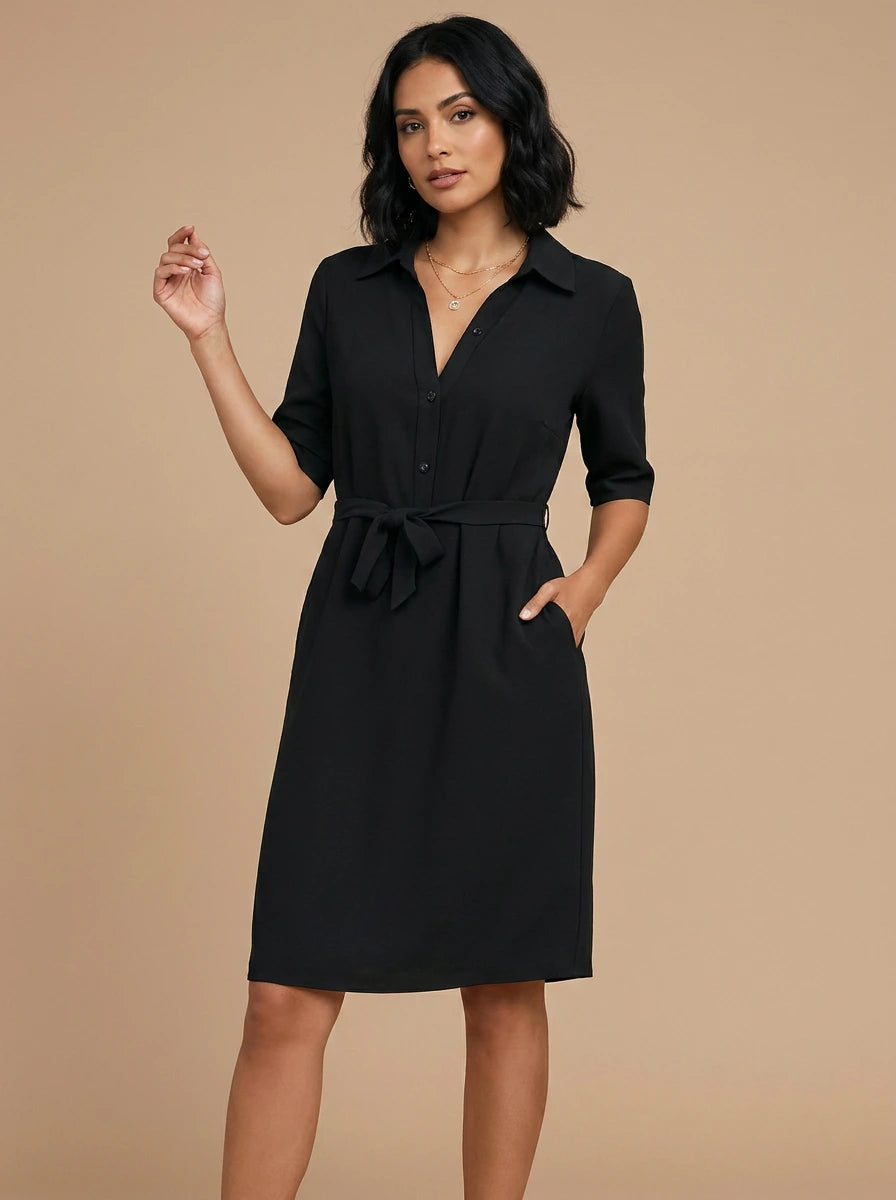 Woman wearing a black v-neck midi dress, studio photo, front pose