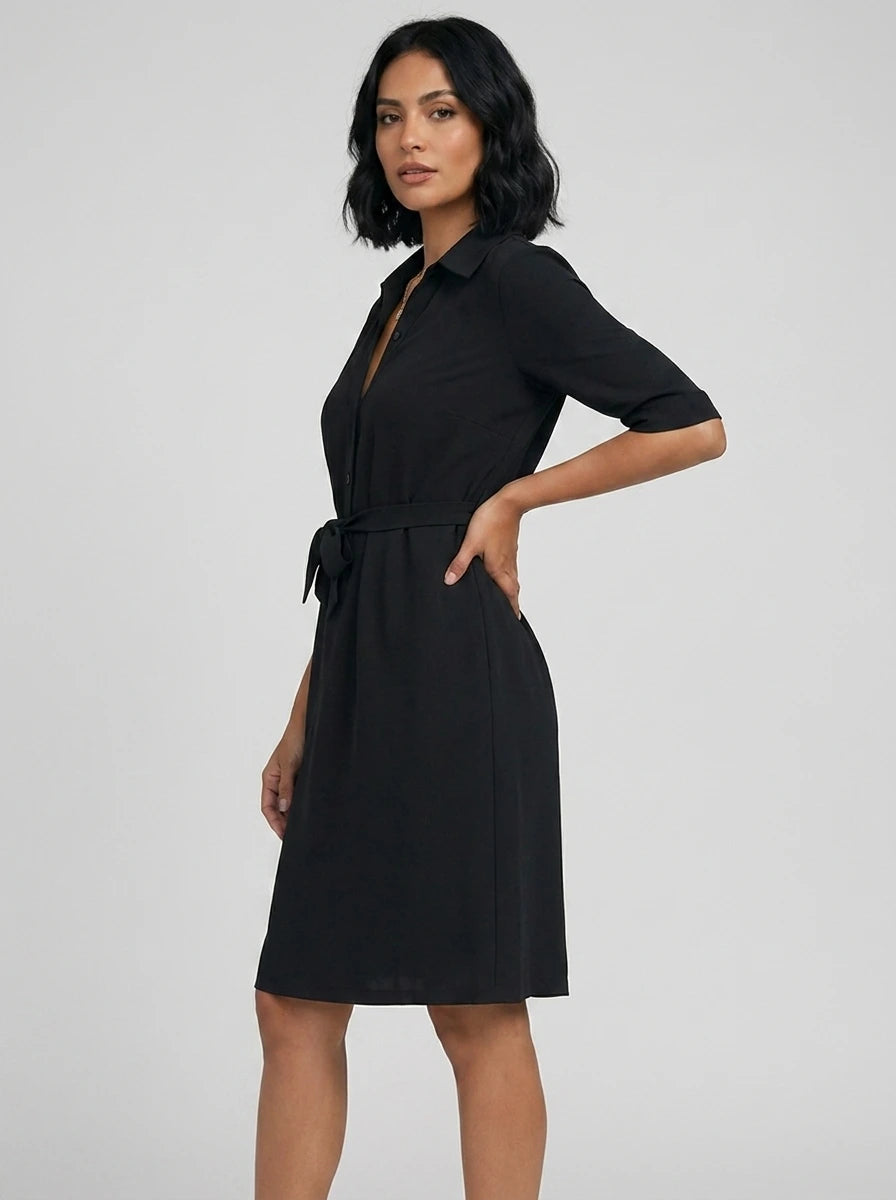 Woman wearing a black v-neck midi dress, studio photo, side pose