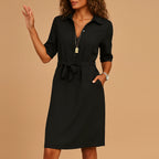 Woman wearing a black v-neck midi dress - studio photo