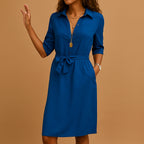 Woman wearing a royal blue v-neck midi dress - studio photo