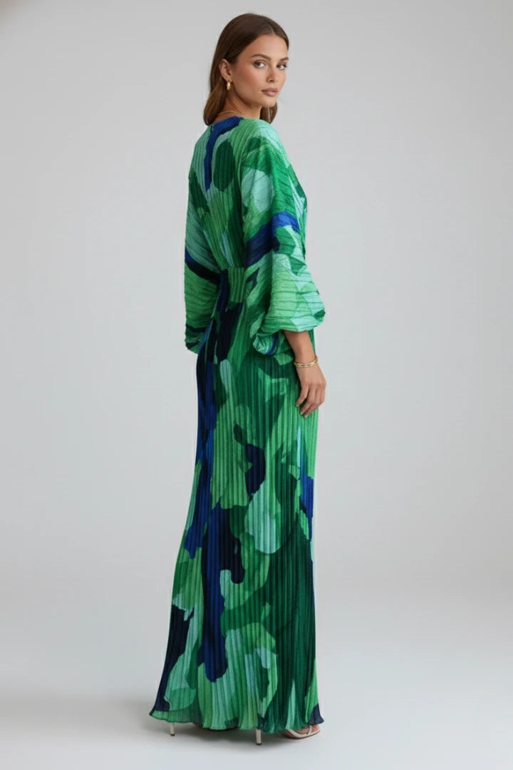Woman wearing a green v-neck pleated maxi dress - studio photo