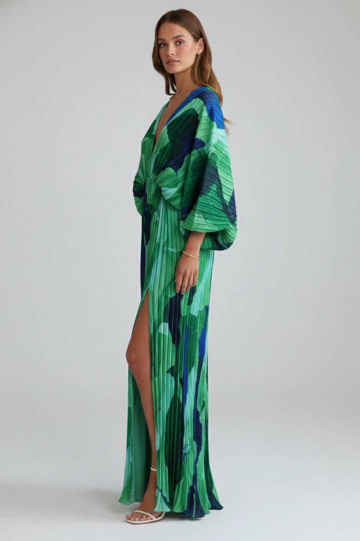 Woman wearing a green v-neck pleated maxi dress - studio photo