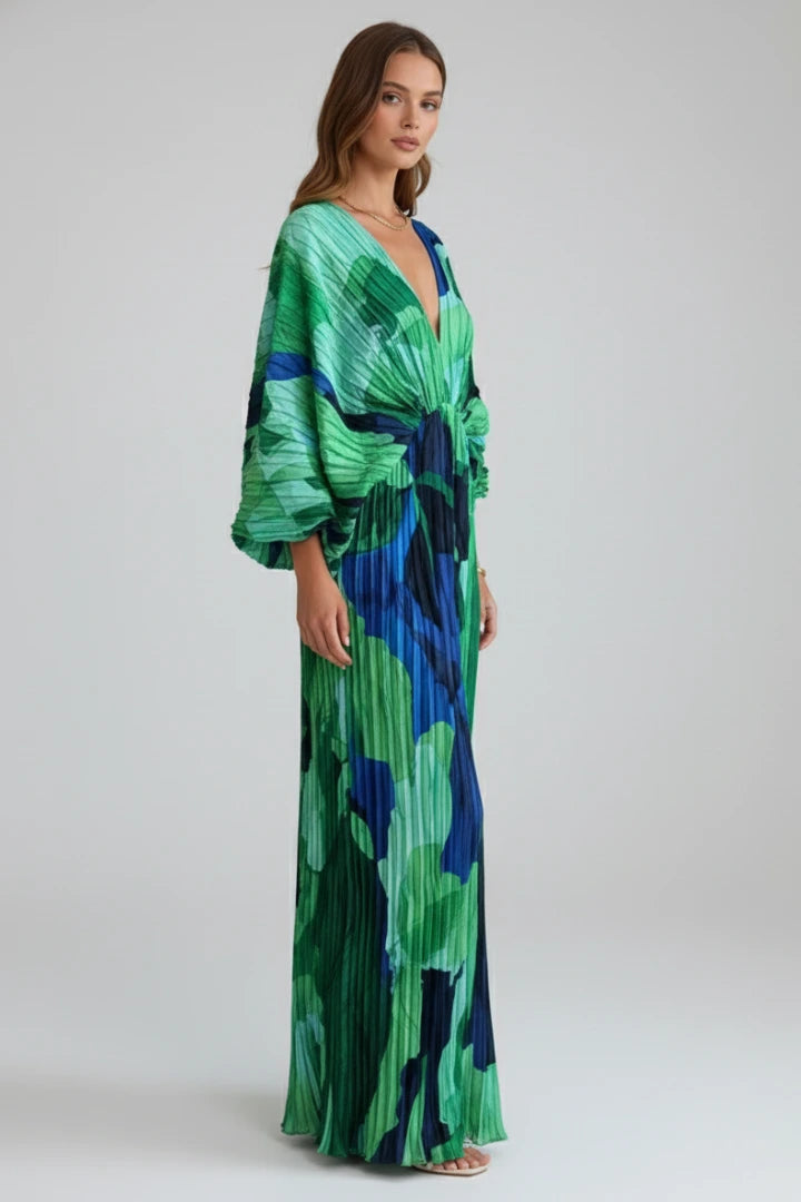 Woman wearing a green v-neck pleated maxi dress - studio photo