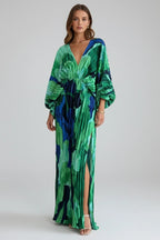 Woman wearing a green v-neck pleated maxi dress - studio photo