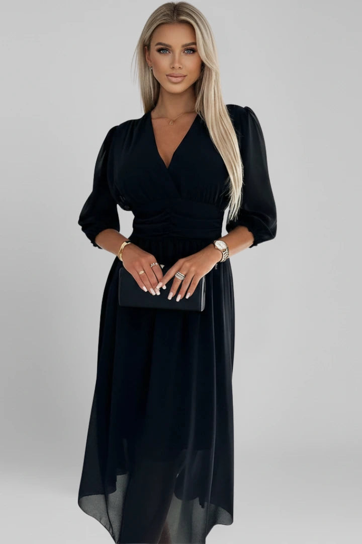 Woman wearing a black v-neck wrap waist dress - studio photo