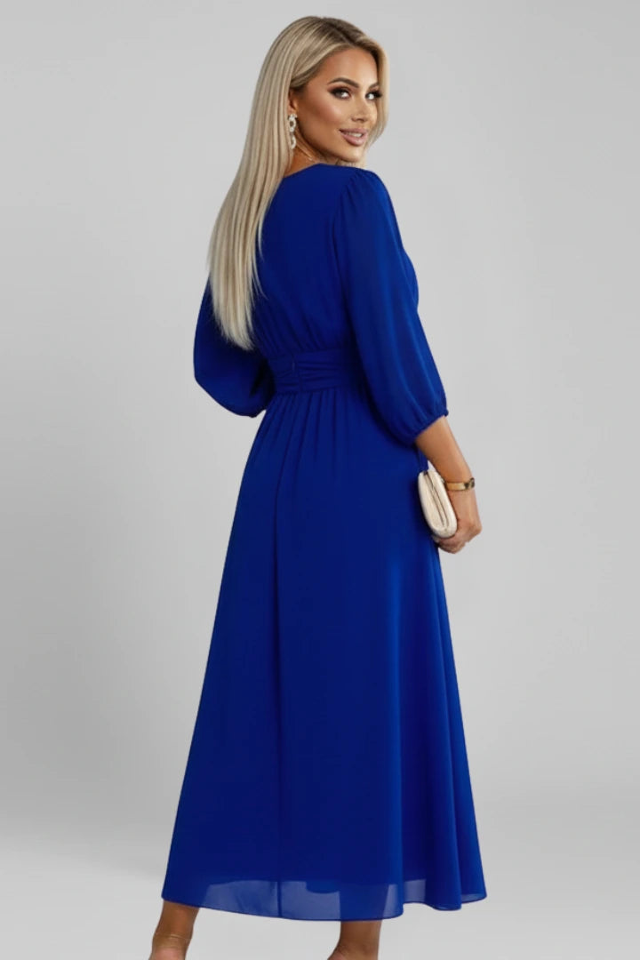 Woman wearing a blue v-neck wrap waist dress - studio photo