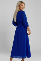 Woman wearing a blue v-neck wrap waist dress - studio photo