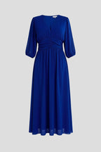 Woman wearing a blue v-neck wrap waist dress - studio photo