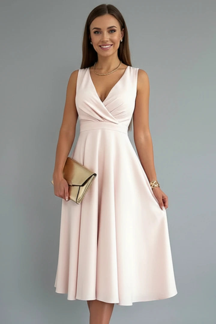 Woman wearing a apricot v-neck zip closure midi dress - studio photo
