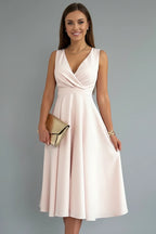 Woman wearing a apricot v-neck zip closure midi dress - studio photo